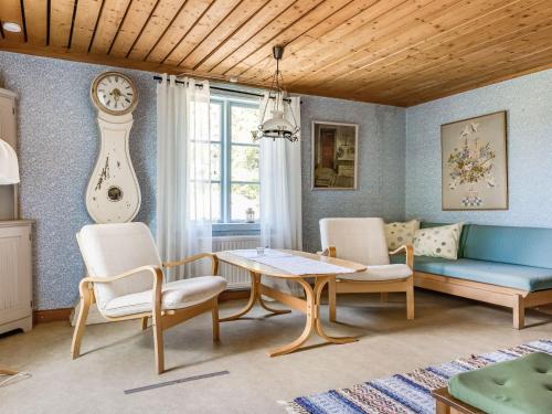 a living room with a table and chairs and a couch at Holiday Home Ebbabolet by Interhome in Tibro