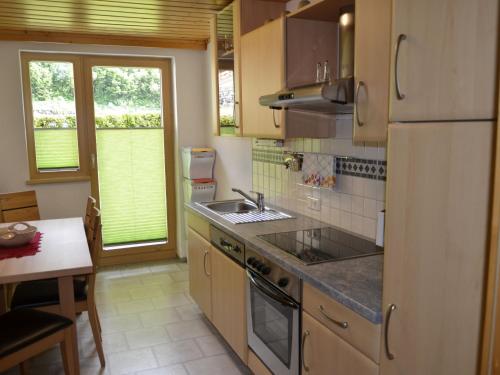 a kitchen with a sink and a stove top oven at Apartment Apart Garni Wachter - KPL645 by Interhome in Kappl