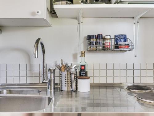 a kitchen counter with a sink and a bottle of wine at Holiday Home Bergkvara by Interhome in Bergkvara