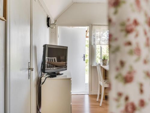a living room with a television and a table at Holiday Home Bergkvara by Interhome in Bergkvara