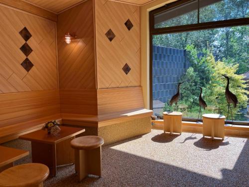 a room with a room with a window and stools at Holiday Home Erzeberg-1 by Interhome in Balhorn