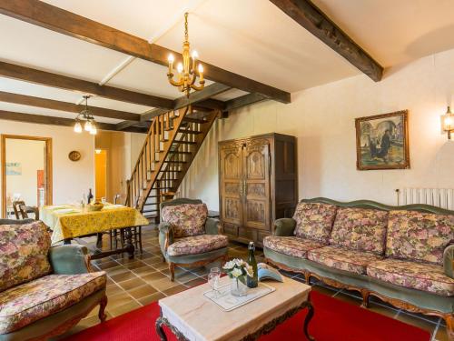 a living room with couches and a table at Holiday Home Ker Glaz by Interhome in La Forêt-Fouesnant