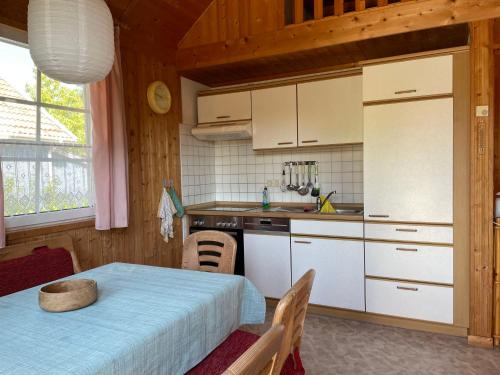 a kitchen with white cabinets and a table in a room at Holiday Home Useriner See-4 by Interhome in Userin