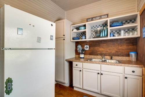 a kitchen with a sink and a refrigerator at New Braunfels Vacation Rental on Lake Dunlap! in New Braunfels