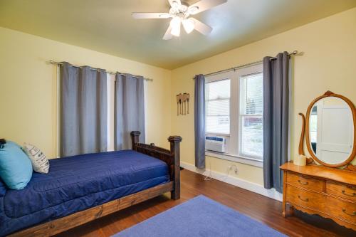 a bedroom with a bed and a mirror and a ceiling fan at New Braunfels Vacation Rental on Lake Dunlap! in New Braunfels