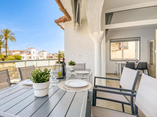 a dining table on a balcony with a view at Holiday Home Sunset by Interhome in Empuriabrava