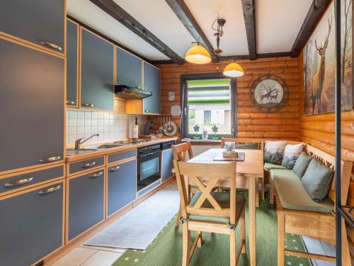 a kitchen with a table and a dining room at Apartment Am Hohen Bogen-18 by Interhome in Arrach