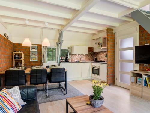 a kitchen and living room with a table and chairs at Holiday Home De Schans by Interhome in Anjum