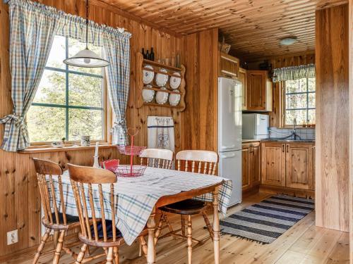 a kitchen with a table and chairs in a room at Holiday Home Bofall by Interhome in Södra Vi