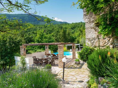 a patio with a table and chairs and a pool at Holiday Home Luna by Interhome in Brseč