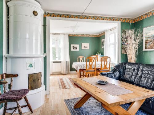 a living room with a couch and a table at Holiday Home Ilingetorp - SND032 by Interhome in Torsås