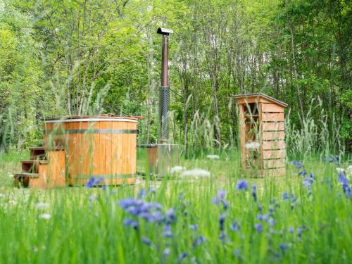 a garden with a wooden barrel and a bird house at Chalet Birchwood Cottage by Interhome in Inverness