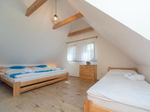 a bedroom with two beds in a attic at Holiday Home Cilka 2 by Interhome in Stráž nad Nežárkou
