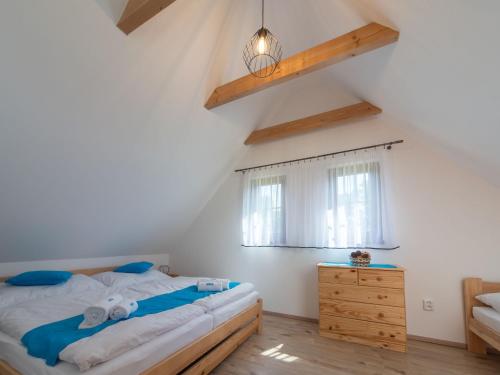 a bedroom with a bed and a wooden dresser at Holiday Home Cilka 2 by Interhome in Stráž nad Nežárkou