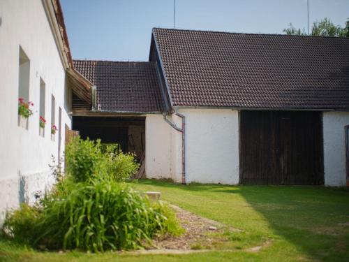 an old white building with a gate and a yard at Holiday Home Kojetice na Moravě by Interhome in Kojetice