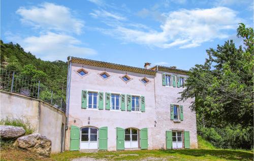 an old building with green and pink doors and windows at Beautiful Home In Die in Die