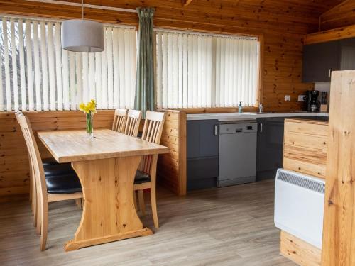 a kitchen and dining room with a table and chairs at Holiday Home Achmony Number 6 by Interhome in Drumnadrochit