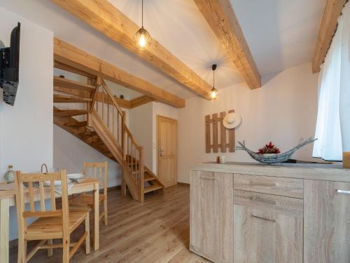 a kitchen and dining room with a wooden staircase at Holiday Home Cilka 1 by Interhome in Stráž nad Nežárkou