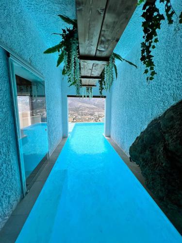 a blue room with a blue floor and a ceiling at Aegialis Hotel & Spa in Aegiali