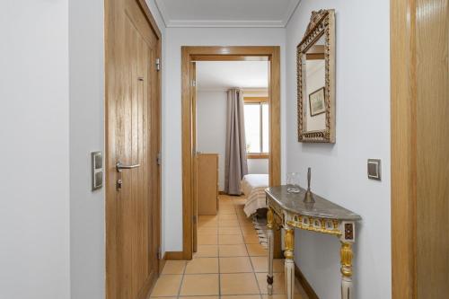a hallway with a bathroom with a sink and a mirror at Casa Anaim by Homie in Lapeiras