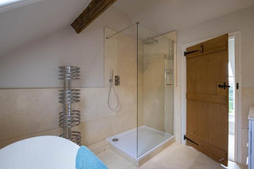 a shower with a glass door in a bathroom at Five Acres in Thirsk