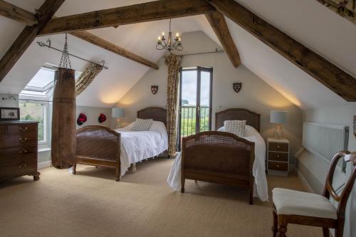 a bedroom with two beds and a window at Five Acres in Thirsk