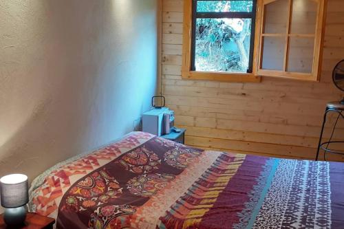 Ένα ή περισσότερα κρεβάτια σε δωμάτιο στο LOU CABANOT CHALET DE JARDIN CALME ET CONFORTABLE