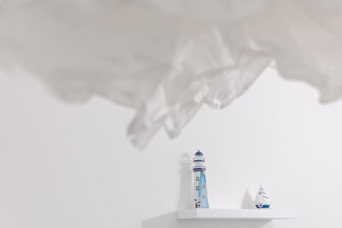 a figurine of a lighthouse on a shelf at La barca apartments in Becici