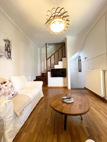 a living room with a bed and a table at Ostraco Aphytis in Afitos