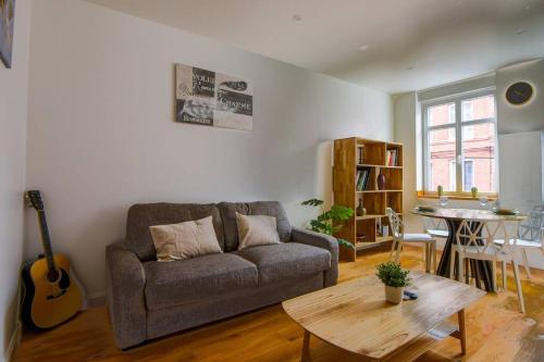 un salon avec un canapé et une table dans l'établissement Très Bel Apart Lumineux et Comfortable, à Lille