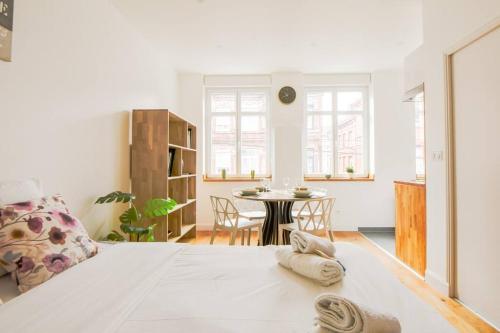 un salon avec un lit et une table dans l'établissement Très Bel Apart Lumineux et Comfortable, à Lille