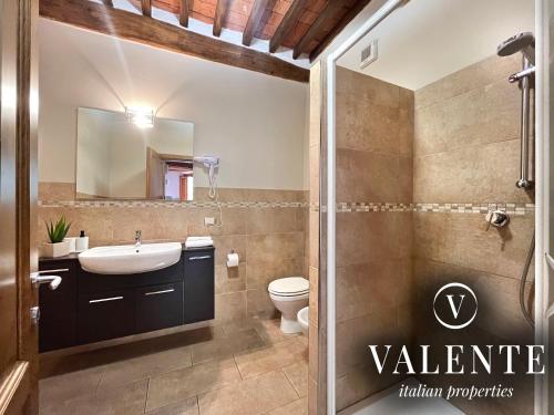 a bathroom with a sink and a toilet at Via Ruga degli Orlandi - Valente Italian Properties in Pescia