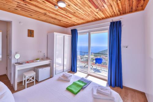 a bedroom with a bed and a large window at Elit Hotel Kas in Kaş
