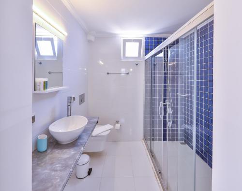 a bathroom with a sink and a toilet and a shower at Elit Hotel Kas in Kaş