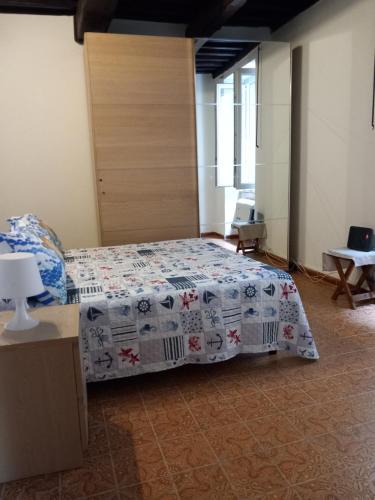 a bedroom with a bed with a comforter on it at Da Isabella in Vernazza