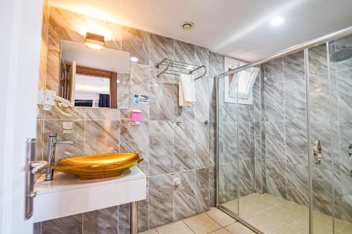 a bathroom with a sink and a shower at MITANI SUITES in Istanbul