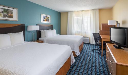 a hotel room with two beds and a flat screen tv at Fairfield Inn & Suites Temple Belton in Temple