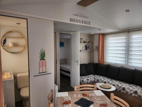 un soggiorno con divano e tavolo di Muriel Le Mar Estang a Canet-en-Roussillon