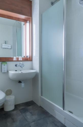 a bathroom with a sink and a toilet at Campanile Nogent-Sur-Marne in Nogent-sur-Marne