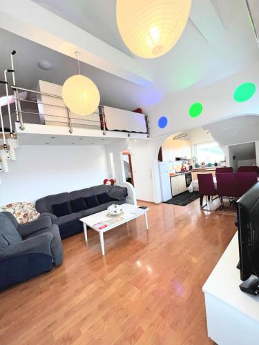 a living room with a couch and a loft bed at Penthouse Familly Orešković in Zagreb