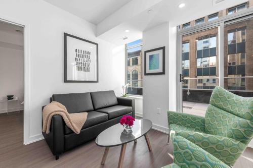 a living room with a couch and two chairs at reStays Ottawa in Ottawa