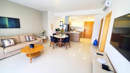 a living room with a couch and a table at Amar'e Aparthotel & Spa in Las Terrenas