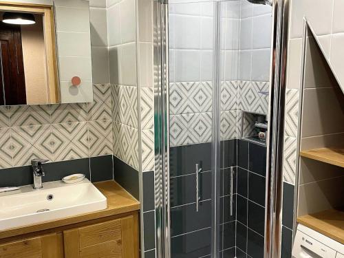 une salle de bain avec douche et lavabo dans l'établissement Charmant duplex au centre de Samoëns avec balcon, WiFi et parking - FR-1-629-115, à Samoëns