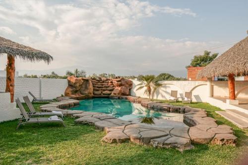 a backyard with a swimming pool with a water slide at Beautiful, cozy and modern new home in Cuernavaca in Cuernavaca