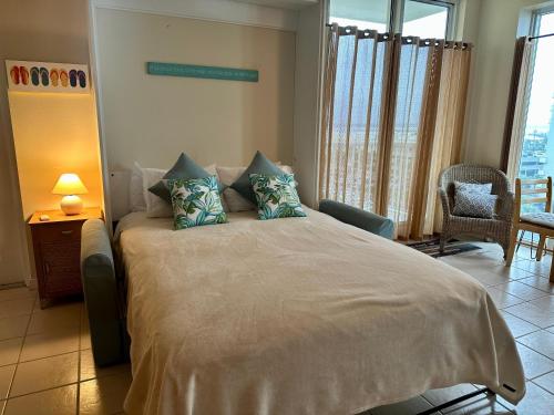 a bedroom with a large bed with pillows on it at Caribbean Resort 501A - Link To The Beach in Navarre