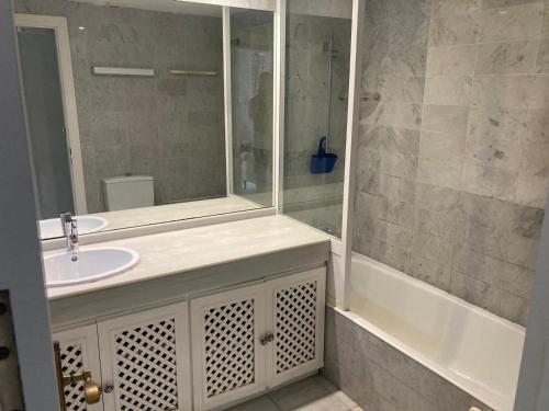 a bathroom with a sink and a mirror and a tub at Casa Pio Pio in Novo Sancti Petri