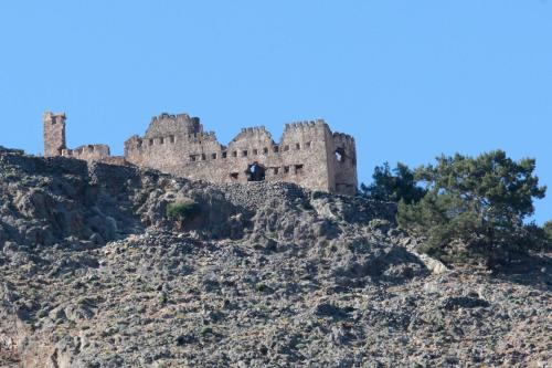 a castle on top of a mountain at Paralia guest house in Agia Roumeli