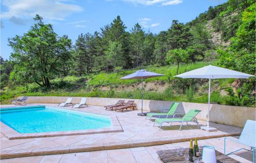 a swimming pool with lounge chairs and umbrellas next to at Beautiful Home In Die in Die