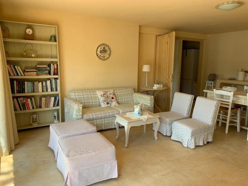 a living room with a couch and chairs and a table at Endless Seaview in Porto Rafti