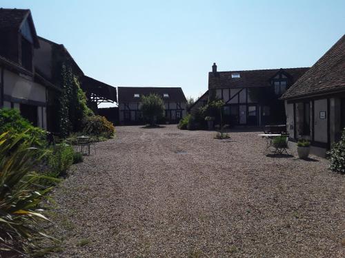 a gravel road between two houses in a village at La Belvinière Chambres et table d'hôtes in Tour-en-Sologne